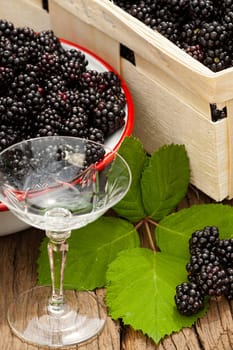 Harvest-fresh forest blackberries and a liqueur glass