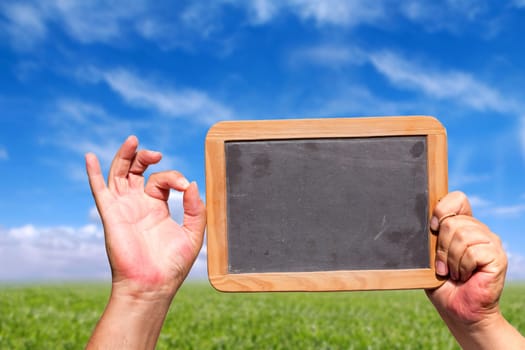 Hand shows OK icon and holds blank board