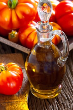 Fresh meat tomatoes and carafe with olive oil