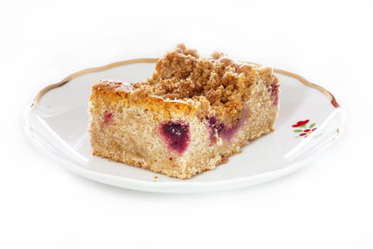 A piece of plum cake on a plate