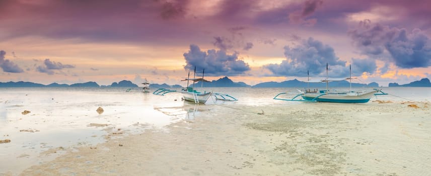 Traditional philippine boats bangka at sunset time. Panorama