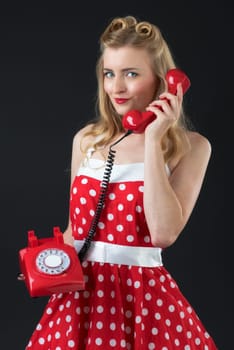 a woman in a red dress with punketen holding a red phone in her hand
