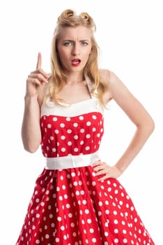 a woman in rockabilly style looks serious and lifts her finger
