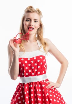 a woman in dotted summer dress holds a brille