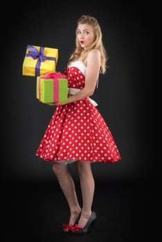 a woman in rockabilly style with dotted dress keeps gifts