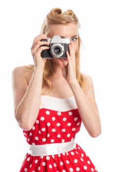 A woman in rockebilly style photographed with an old camera