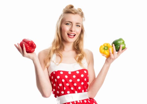 a woman in summer dress holds various peppers