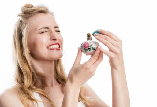 a woman in rockabilly style sprays with a perfume atomizer