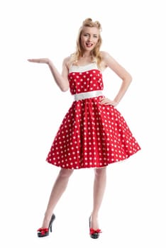 young woman in rockabilly dress shows with hand