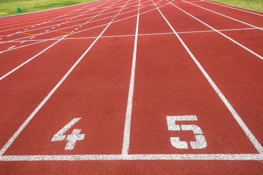 Athletic one hundred meter starting line at lanes four and five for sprinters.