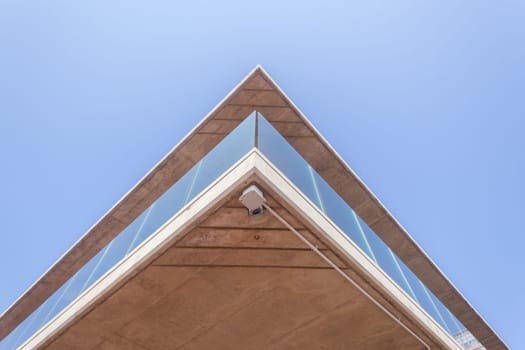 Building corner in concrete glass abstract section in blue sky