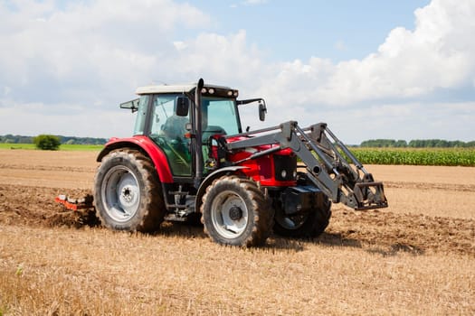 Tractor with plow in the field.