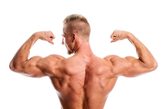 a well-trained young man shows his muscles