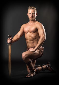 a muscular man with a sword in pose