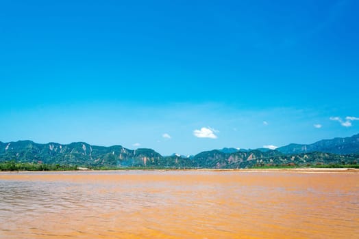 View of the Beni River with lush green hills in the background near Rurrenabaque, Bolivia