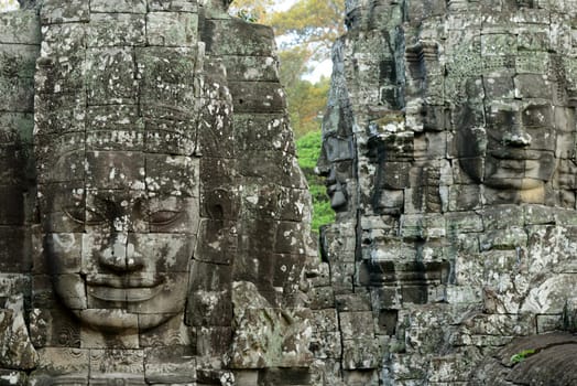 Stone Faces the Tempel Ruin of Angkor Thom in the Temple City of Angkor near the City of Siem Riep in the west of Cambodia.
