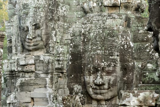 Stone Faces the Tempel Ruin of Angkor Thom in the Temple City of Angkor near the City of Siem Riep in the west of Cambodia.