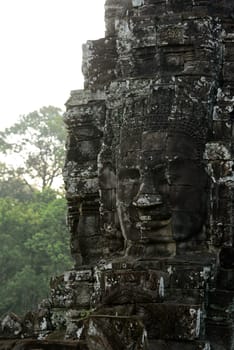 Stone Faces the Tempel Ruin of Angkor Thom in the Temple City of Angkor near the City of Siem Riep in the west of Cambodia.