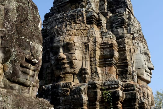 Stone Faces the Tempel Ruin of Angkor Thom in the Temple City of Angkor near the City of Siem Riep in the west of Cambodia.