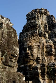 Stone Faces the Tempel Ruin of Angkor Thom in the Temple City of Angkor near the City of Siem Riep in the west of Cambodia.