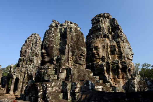 Stone Faces the Tempel Ruin of Angkor Thom in the Temple City of Angkor near the City of Siem Riep in the west of Cambodia.