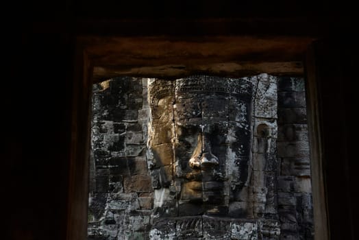 Stone Faces the Tempel Ruin of Angkor Thom in the Temple City of Angkor near the City of Siem Riep in the west of Cambodia.