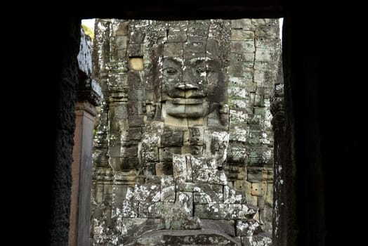 Stone Faces the Tempel Ruin of Angkor Thom in the Temple City of Angkor near the City of Siem Riep in the west of Cambodia.