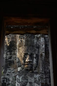 Stone Faces the Tempel Ruin of Angkor Thom in the Temple City of Angkor near the City of Siem Riep in the west of Cambodia.