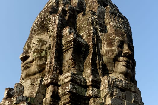 Stone Faces the Tempel Ruin of Angkor Thom in the Temple City of Angkor near the City of Siem Riep in the west of Cambodia.