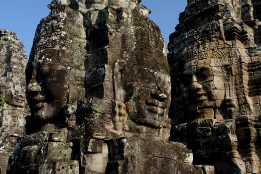 Stone Faces the Tempel Ruin of Angkor Thom in the Temple City of Angkor near the City of Siem Riep in the west of Cambodia.