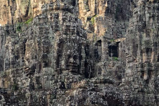 Stone Faces the Tempel Ruin of Angkor Thom in the Temple City of Angkor near the City of Siem Riep in the west of Cambodia.