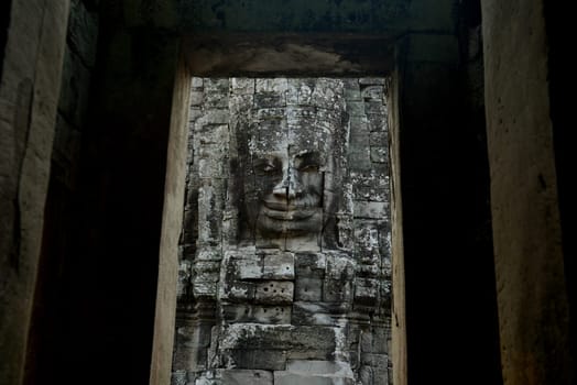 Stone Faces the Tempel Ruin of Angkor Thom in the Temple City of Angkor near the City of Siem Riep in the west of Cambodia.