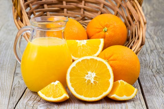 orange juice and fresh fruits on wooden background