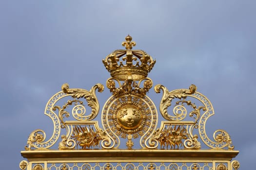 Paris,France – December 30,2013: The archway of the Palace of Versailles decorated with gold and ornaments on 30 December 2013 in Paris.