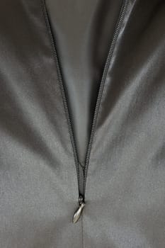 A close up shot of a zipper on a satin dress