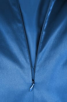 A close up shot of a zipper on a satin dress