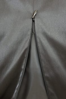 A close up shot of a zipper on a satin dress