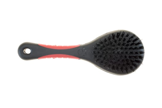 A close up shot of a dogs grooming brush