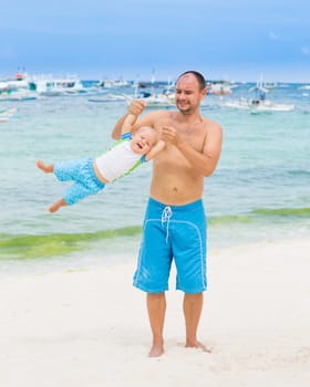Baby and father on the tropical beach