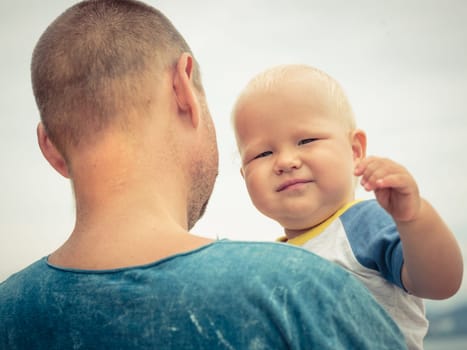 Baby and father outdoor portrait
