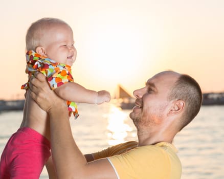 Baby and father on the tropical beach