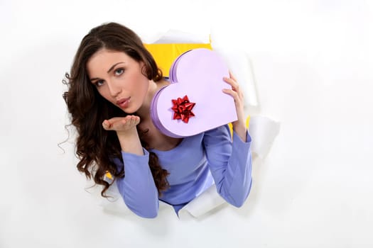 Woman with a heart shaped box of chocolates