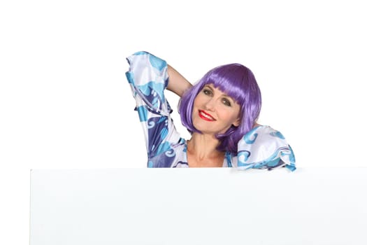 Woman in a purple wig with a blank board ready for your message