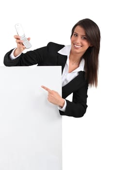Businesswoman pointing at phone