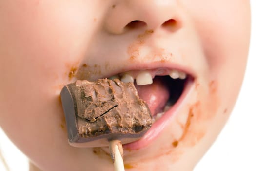 the child eating chocolate lollipop