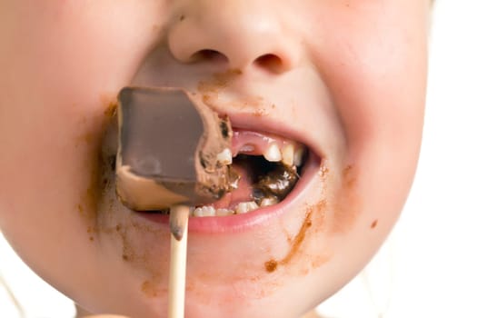 the child eating chocolate lollipop