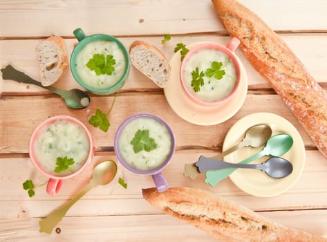 Homemade cream soup with broccoli and fresh baguette