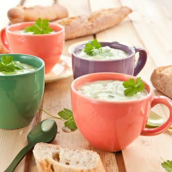 Homemade cream soup with broccoli and fresh baguette