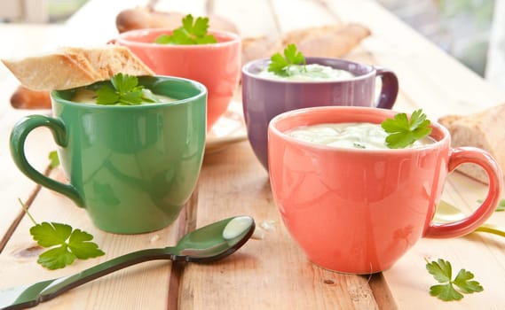Homemade cream soup with broccoli and fresh baguette