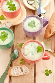 Homemade cream soup with broccoli and fresh baguette